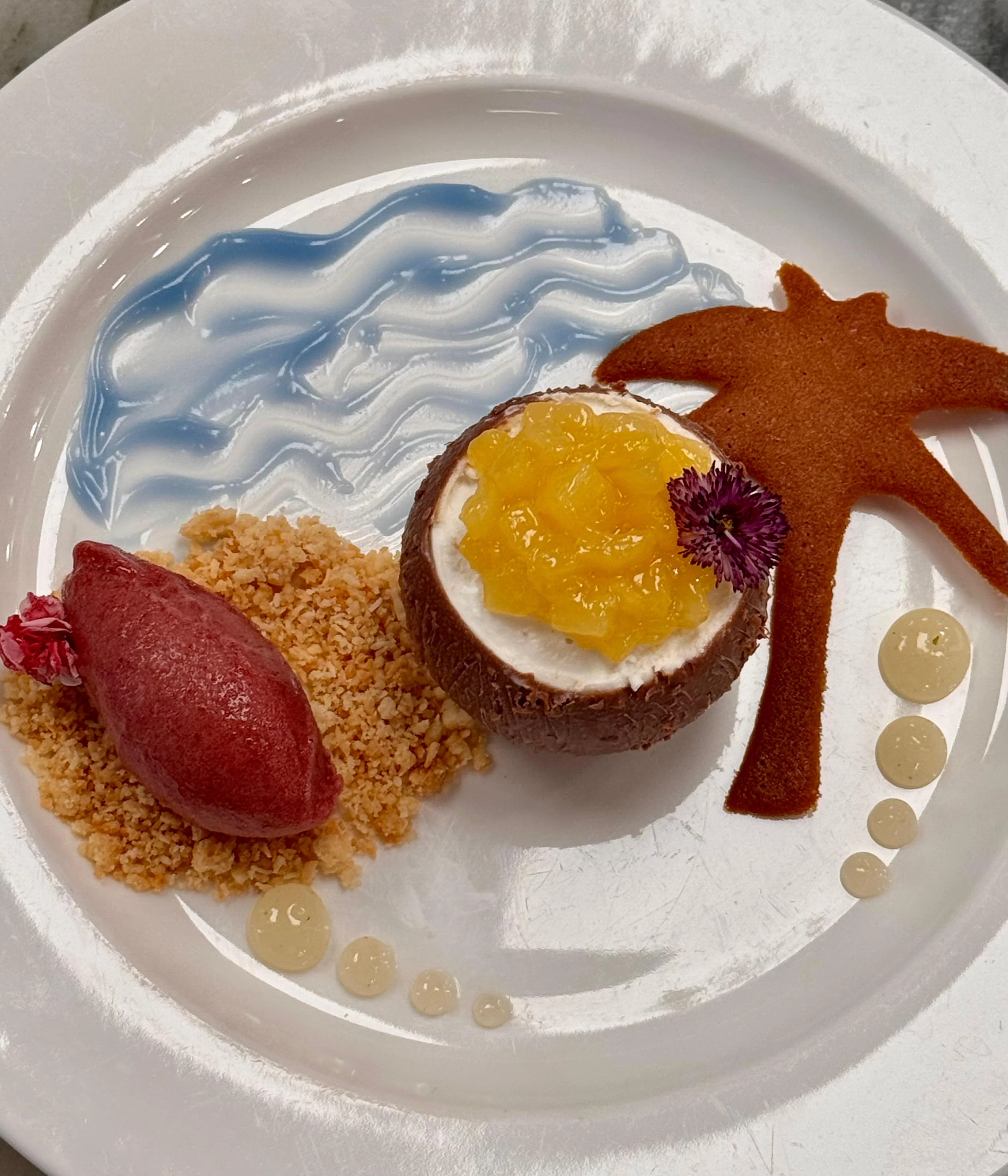 Île Tropicale — coconut shell with mango compote, hibiscus sorbet quenelle and palm tuile